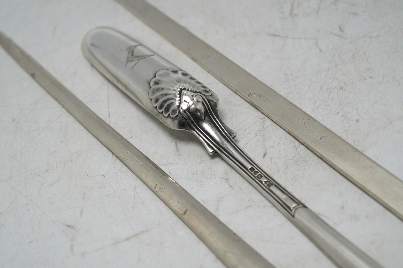 Two George III silver meat skewers by John Lias, London, 1800 and 1801, 29.9cm, together with an Edwardian silver marrow scoop. Condition - fair